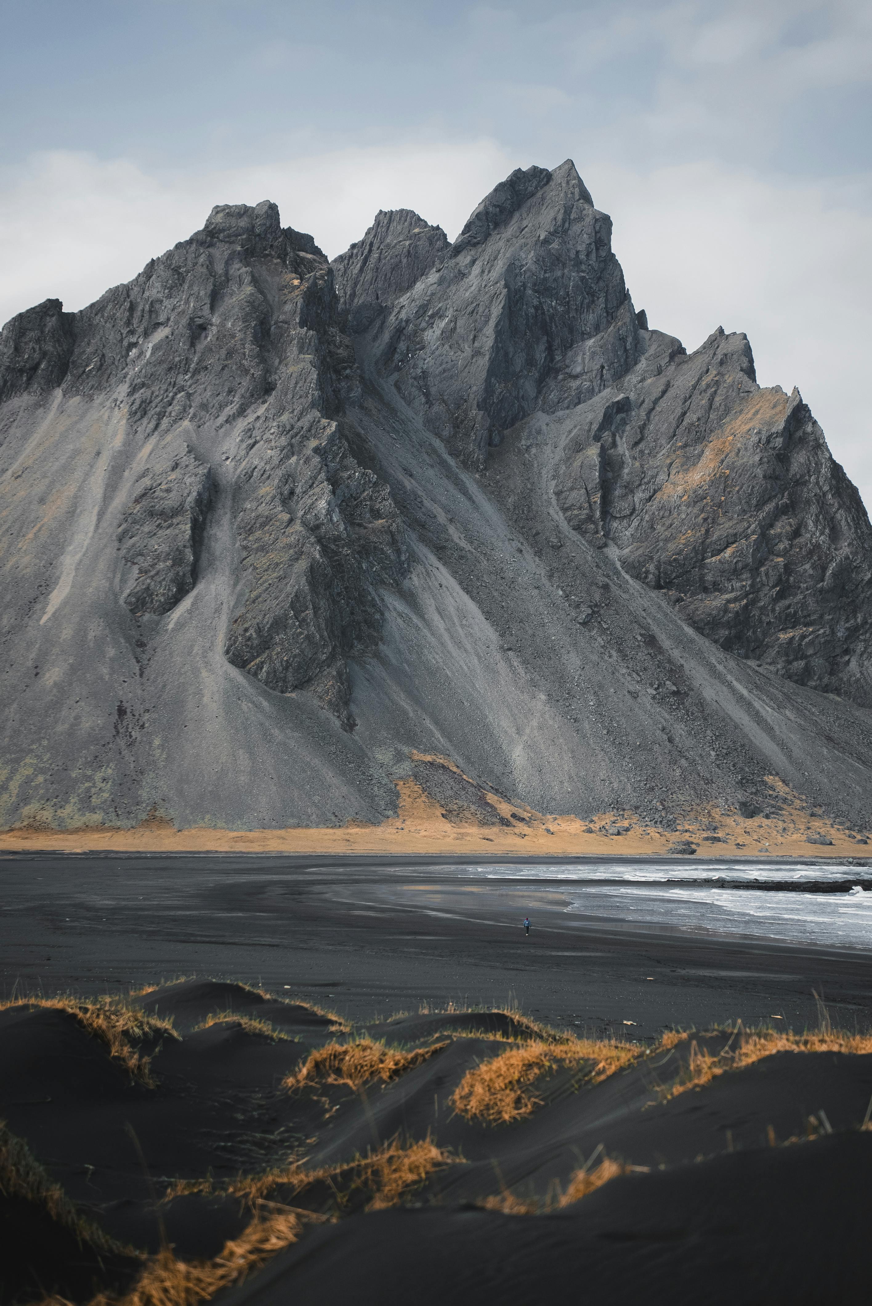 Capture of the towering Vestrahorn Mountain on Iceland's coastline, showcasing dramatic geological formations