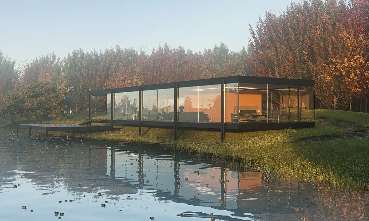 A house made of glass next to a body of water.